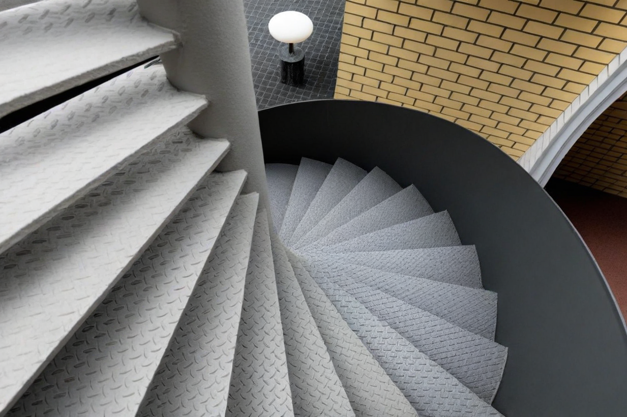 A stylish contemporary spiral staircase with a sophisticated metal structure