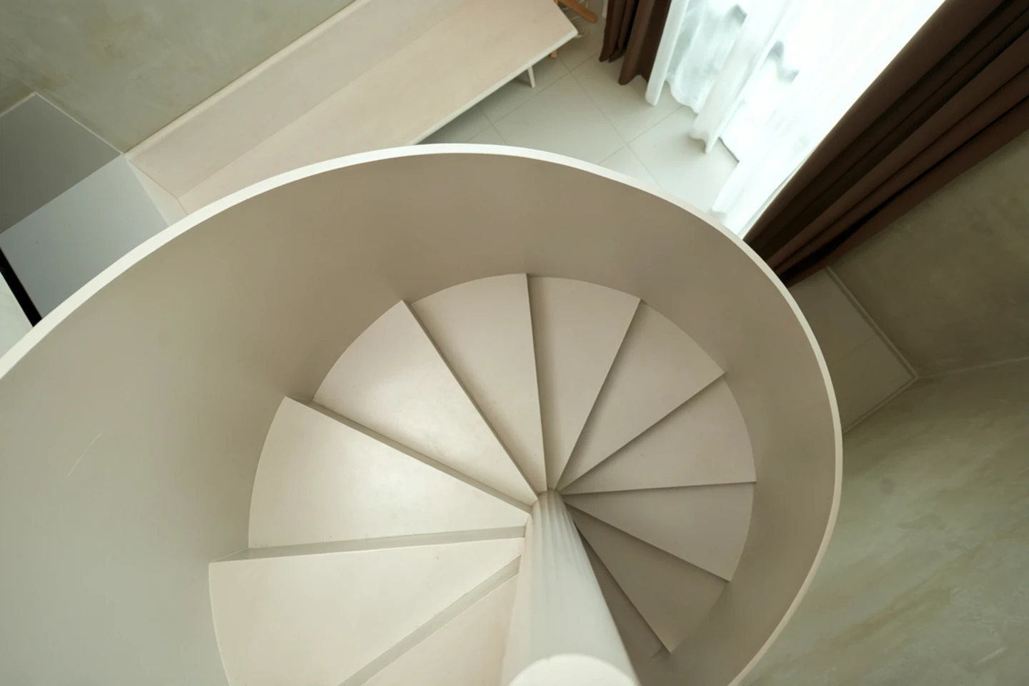 An industrial-style spiral staircase in dark metal